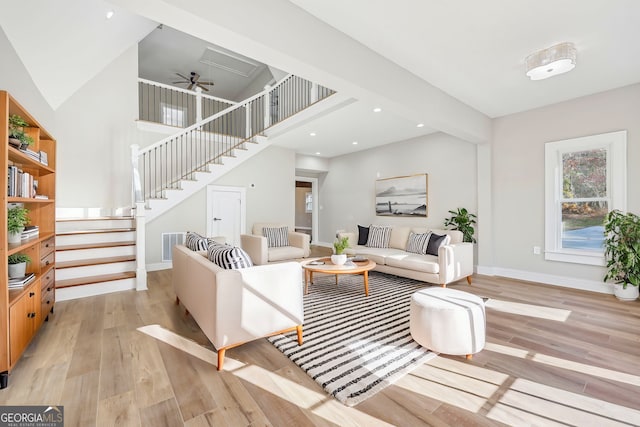 unfurnished living room with light hardwood / wood-style floors and high vaulted ceiling