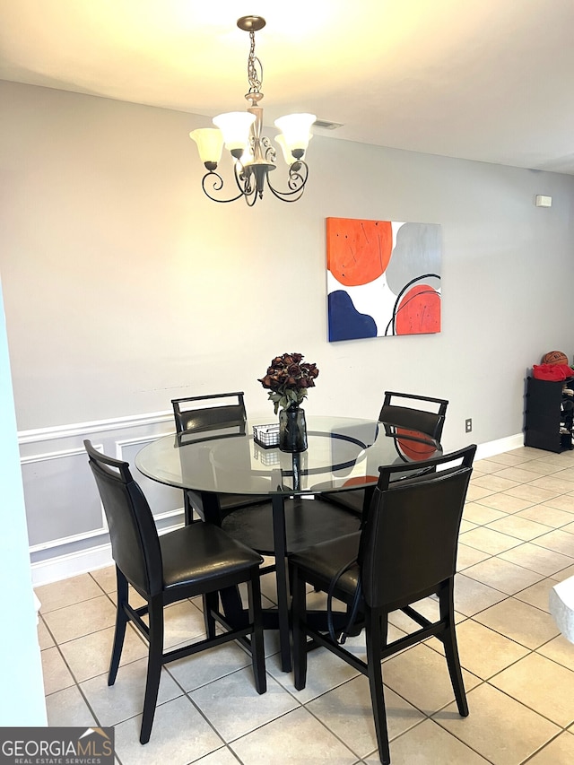 dining space with a notable chandelier and light tile patterned floors