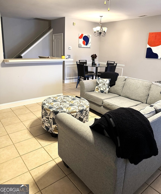 tiled living room with a notable chandelier