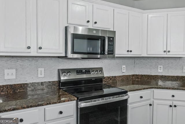 kitchen featuring white cabinets, appliances with stainless steel finishes, and tasteful backsplash