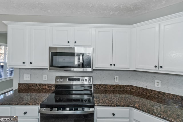 kitchen featuring white cabinets, appliances with stainless steel finishes, and a textured ceiling