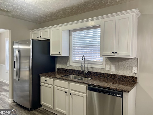 kitchen featuring white cabinets, appliances with stainless steel finishes, dark hardwood / wood-style floors, and sink