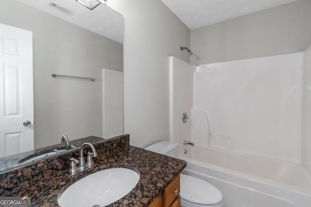 full bathroom featuring shower / tub combination, vanity, a textured ceiling, and toilet