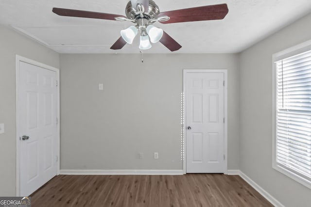 unfurnished bedroom featuring hardwood / wood-style floors and ceiling fan