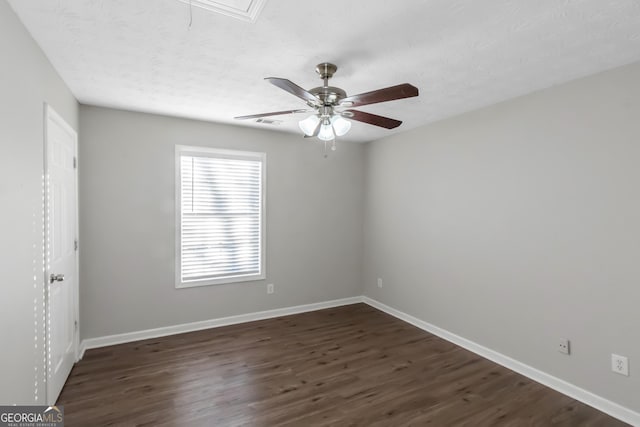 empty room featuring a textured ceiling, ceiling fan, and dark hardwood / wood-style floors