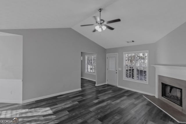 unfurnished living room featuring lofted ceiling, ceiling fan, and dark wood-type flooring