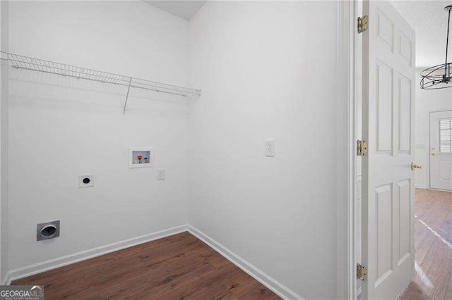 clothes washing area featuring electric dryer hookup, hookup for a washing machine, and hardwood / wood-style flooring