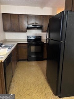 kitchen featuring dark brown cabinetry and black appliances