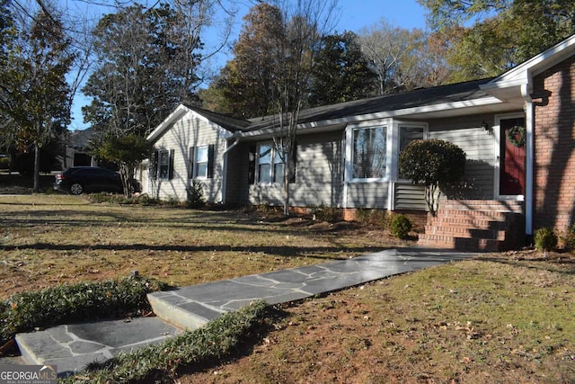 ranch-style home featuring a front yard