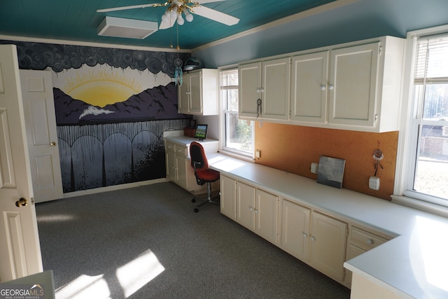 interior space featuring crown molding, carpet flooring, and built in desk