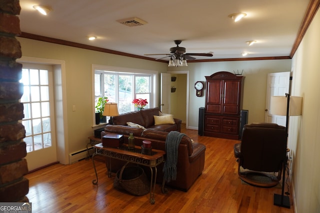 living room featuring hardwood / wood-style flooring, ornamental molding, a baseboard heating unit, and ceiling fan