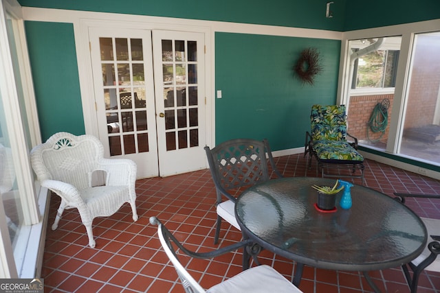 sunroom / solarium featuring french doors