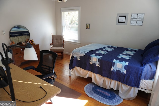 bedroom with hardwood / wood-style flooring