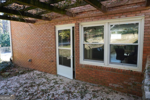 doorway to property featuring a pergola and a patio area