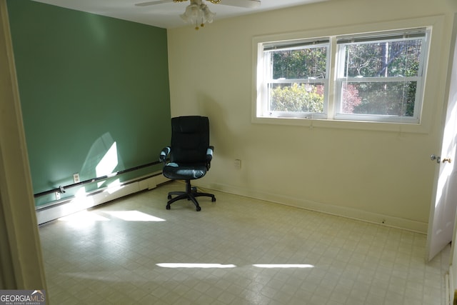 unfurnished office featuring a baseboard heating unit and ceiling fan