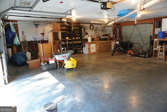 garage with a garage door opener and a workshop area