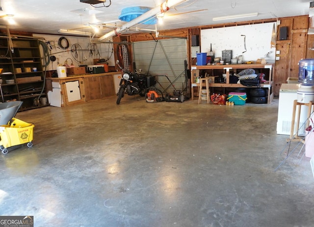 garage featuring a garage door opener and a workshop area