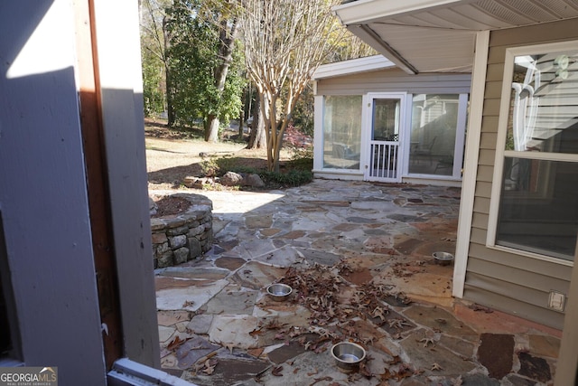 view of patio with a sunroom