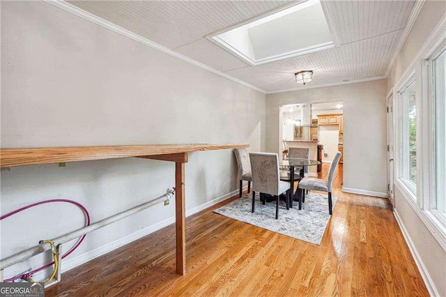 dining room with crown molding and hardwood / wood-style floors