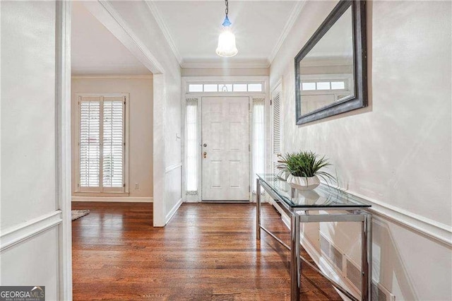 foyer entrance featuring dark hardwood / wood-style floors and ornamental molding