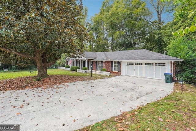 ranch-style house featuring a front lawn and a garage