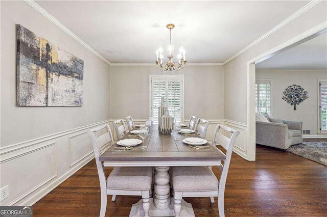 dining room with a chandelier, crown molding, and dark wood-type flooring