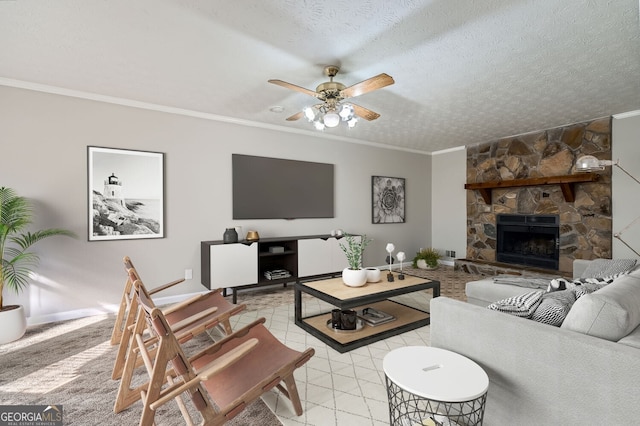 living room featuring ceiling fan, crown molding, a textured ceiling, a fireplace, and light tile patterned floors