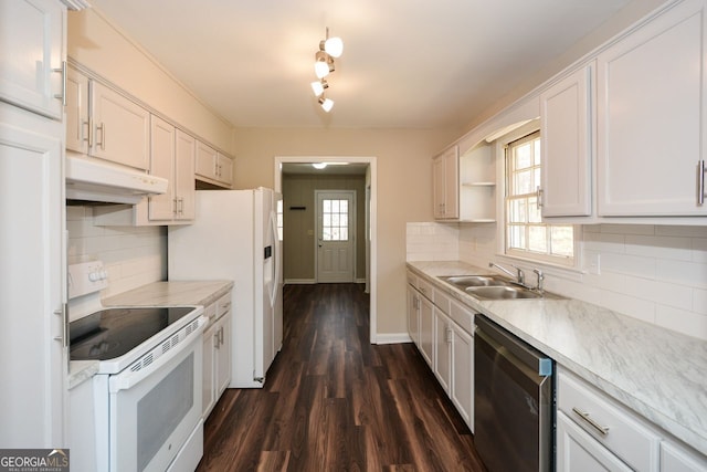 kitchen with white appliances, white cabinetry, sink, backsplash, and dark hardwood / wood-style floors