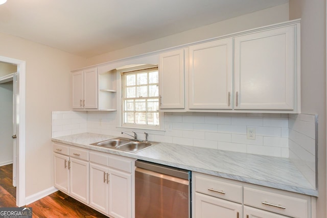 kitchen with stainless steel dishwasher, decorative backsplash, sink, dark wood-type flooring, and white cabinets