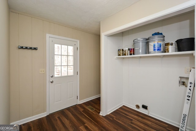 laundry area featuring washer hookup, a textured ceiling, and dark hardwood / wood-style flooring