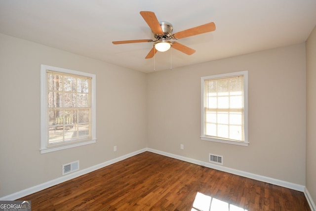 spare room with hardwood / wood-style flooring, ceiling fan, and a healthy amount of sunlight