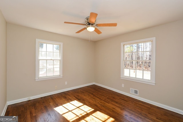 spare room with ceiling fan and dark hardwood / wood-style floors