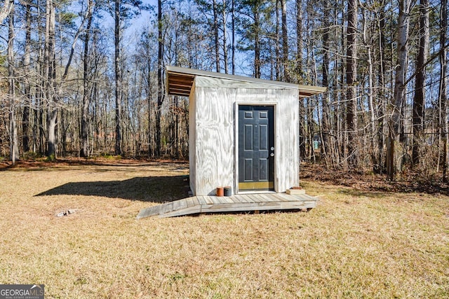 view of outbuilding with a lawn