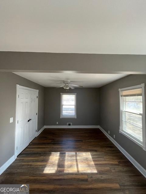 spare room featuring dark hardwood / wood-style floors and ceiling fan