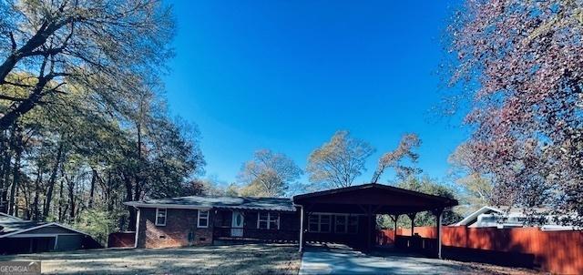 rear view of house featuring a carport