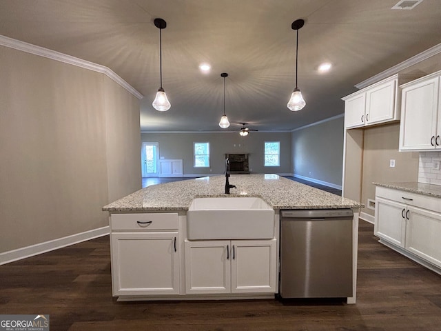 kitchen featuring dishwasher, sink, light stone counters, an island with sink, and white cabinets