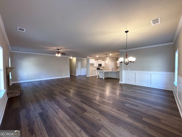 unfurnished living room featuring ceiling fan with notable chandelier, dark hardwood / wood-style flooring, ornamental molding, and sink