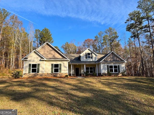 view of front facade featuring covered porch and a front lawn