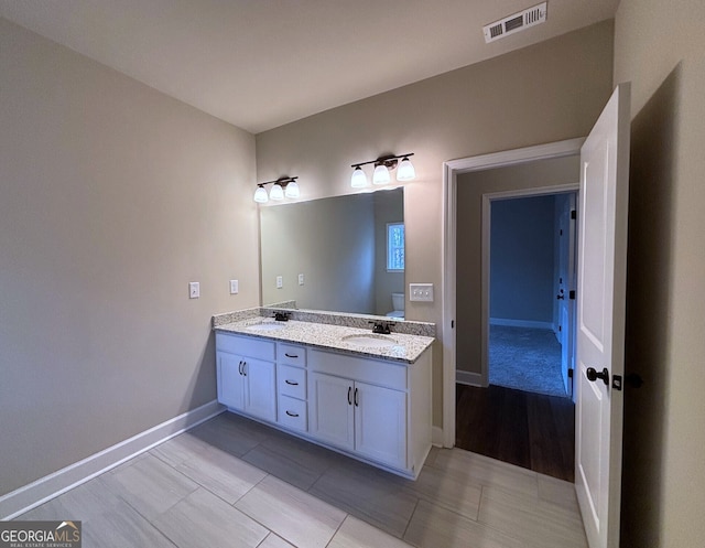 bathroom with hardwood / wood-style floors and vanity