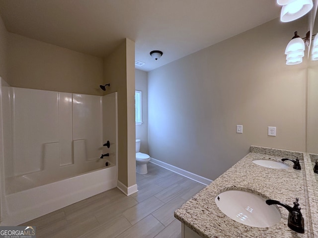 full bathroom featuring hardwood / wood-style floors, vanity, toilet, and washtub / shower combination