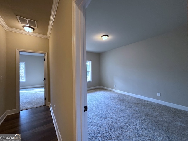 hall with dark hardwood / wood-style flooring and ornamental molding