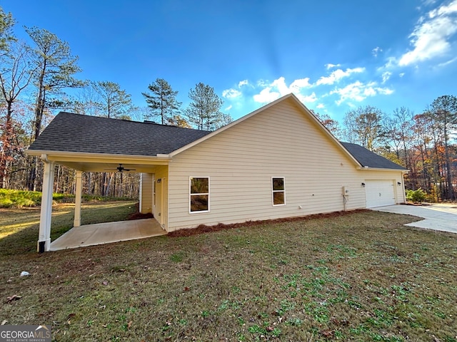 view of home's exterior featuring a lawn, ceiling fan, and a garage