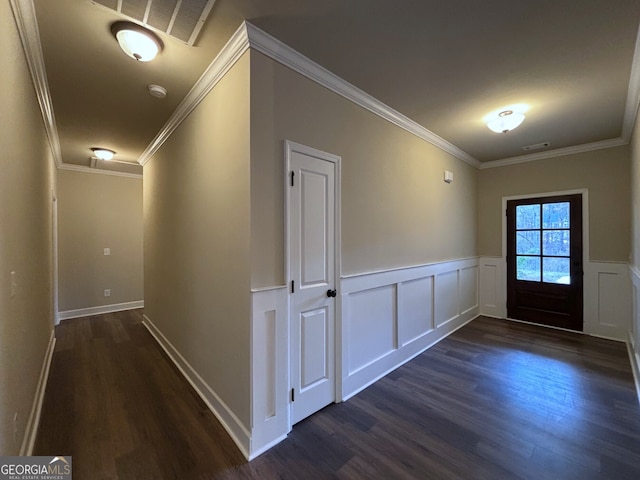 hallway with dark hardwood / wood-style flooring and ornamental molding