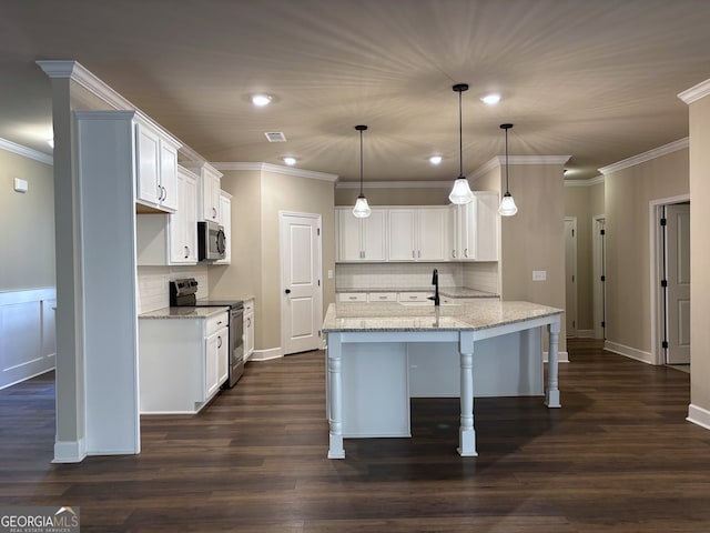 kitchen with pendant lighting, light stone counters, white cabinetry, and appliances with stainless steel finishes