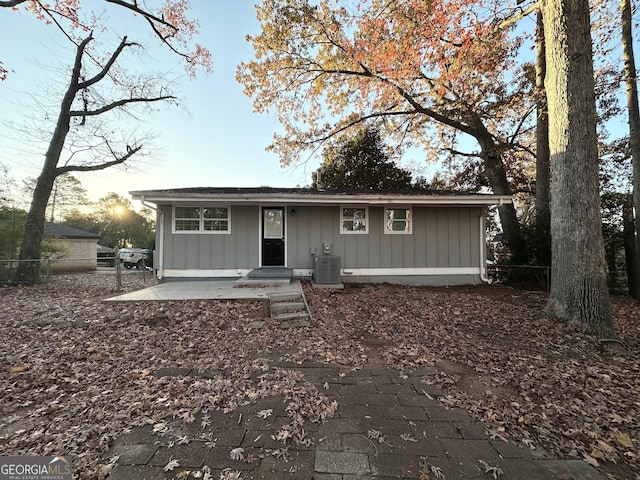 view of front of house with a patio and cooling unit