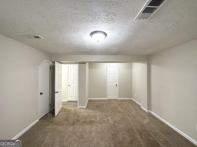 interior space with carpet flooring and a textured ceiling