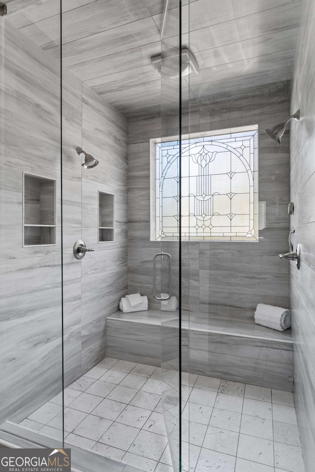 bathroom featuring a shower with door