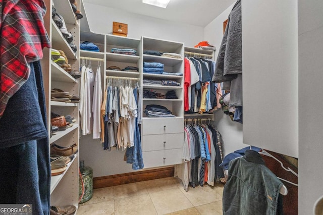 spacious closet with light tile patterned floors