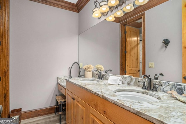 bathroom with hardwood / wood-style flooring, vanity, and ornamental molding