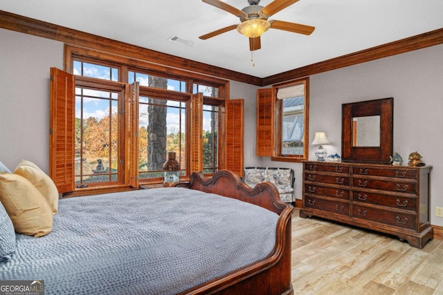 bedroom featuring ceiling fan, light wood-type flooring, and ornamental molding